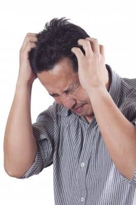 stressed man holding head