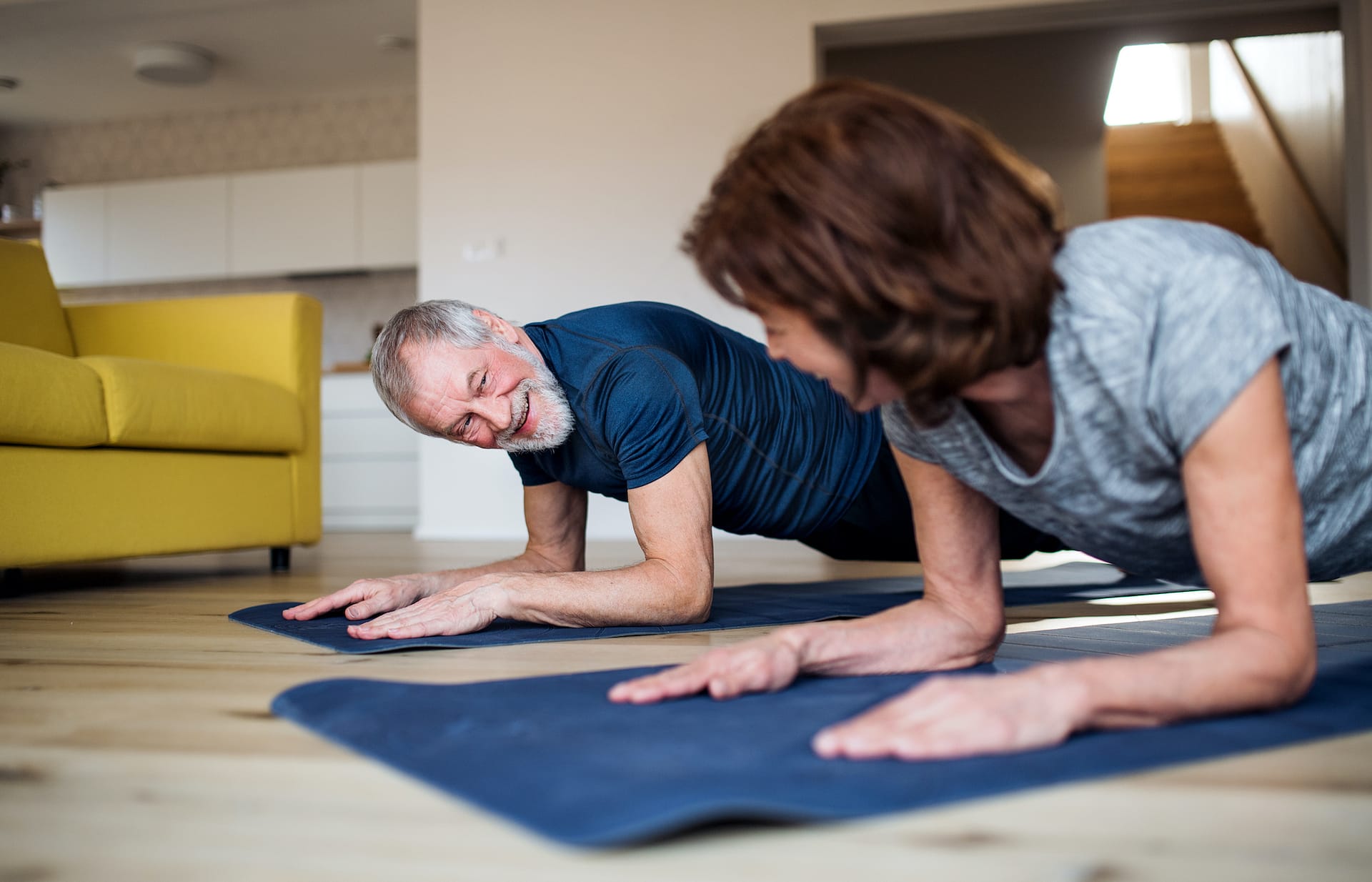 older client couple doing planks